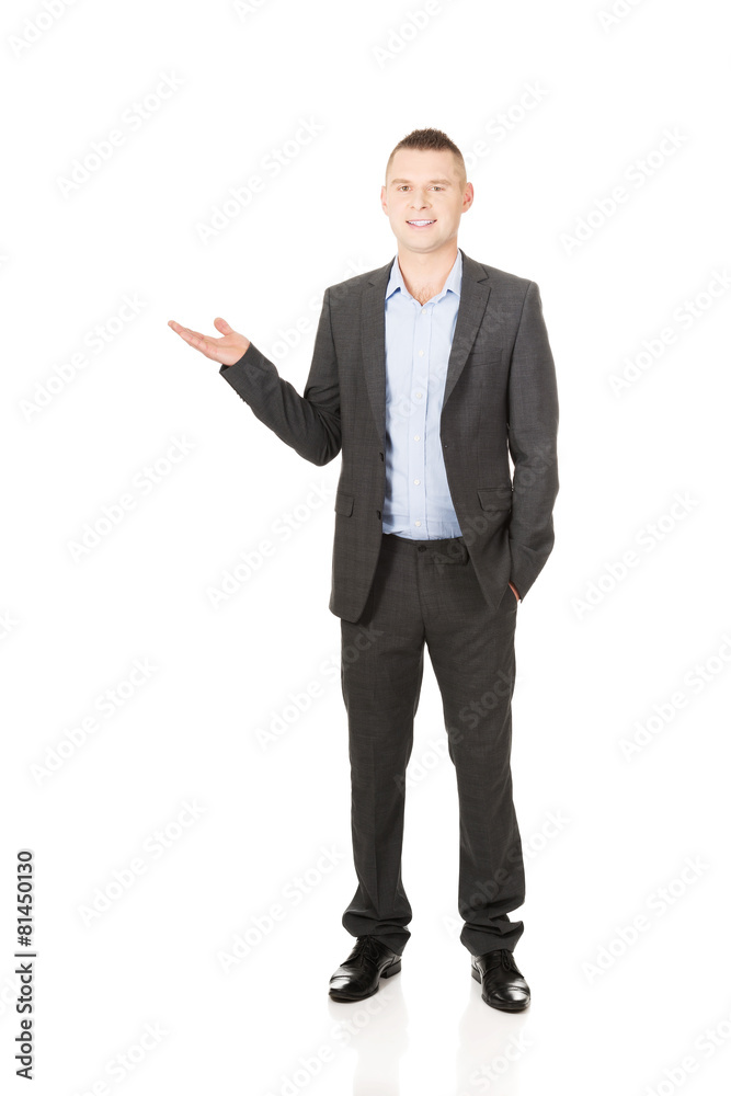 Smiling businessman holding copyspace Smiling businessman holding copyspace