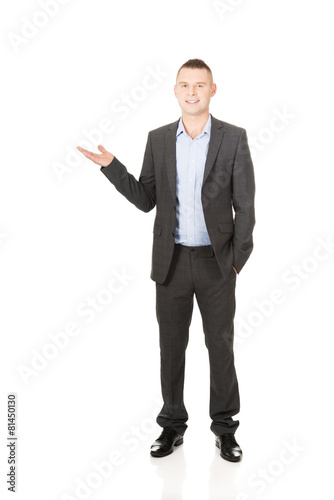 Smiling businessman holding copyspace