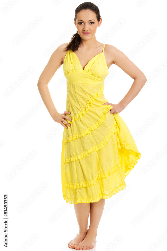 Beautiful female model in yellow dress.