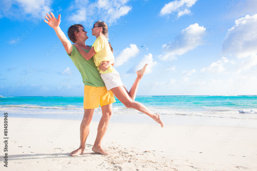 back view of happy young couple on the beach back view of happy young couple on the beach