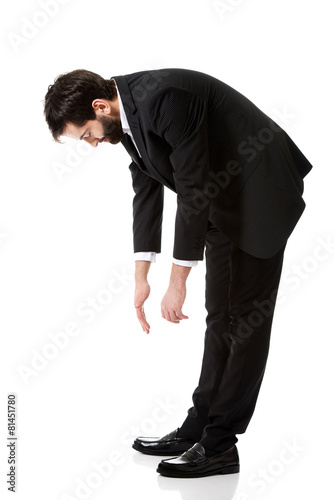 Young businessman bending down. photo