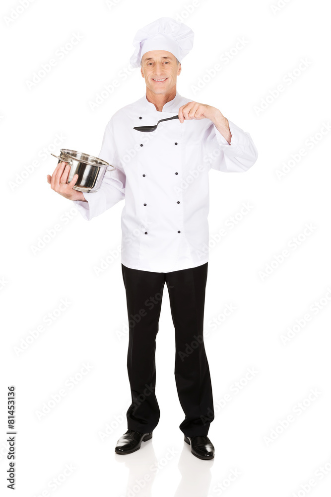 Chef holding stainless steel pot and spoon Chef holding stainless steel pot and spoon