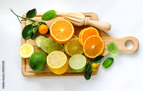 Fototapeta Naklejka Na Ścianę i Meble -  Fresh sliced citrus fruits copy space white background