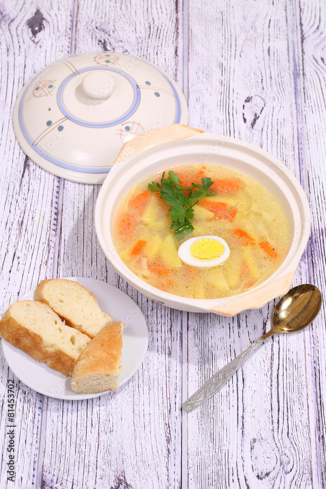 Chicken soup with egg and noodles submitted to a soup tureen Chicken soup with egg and noodles submitted to a soup tureen