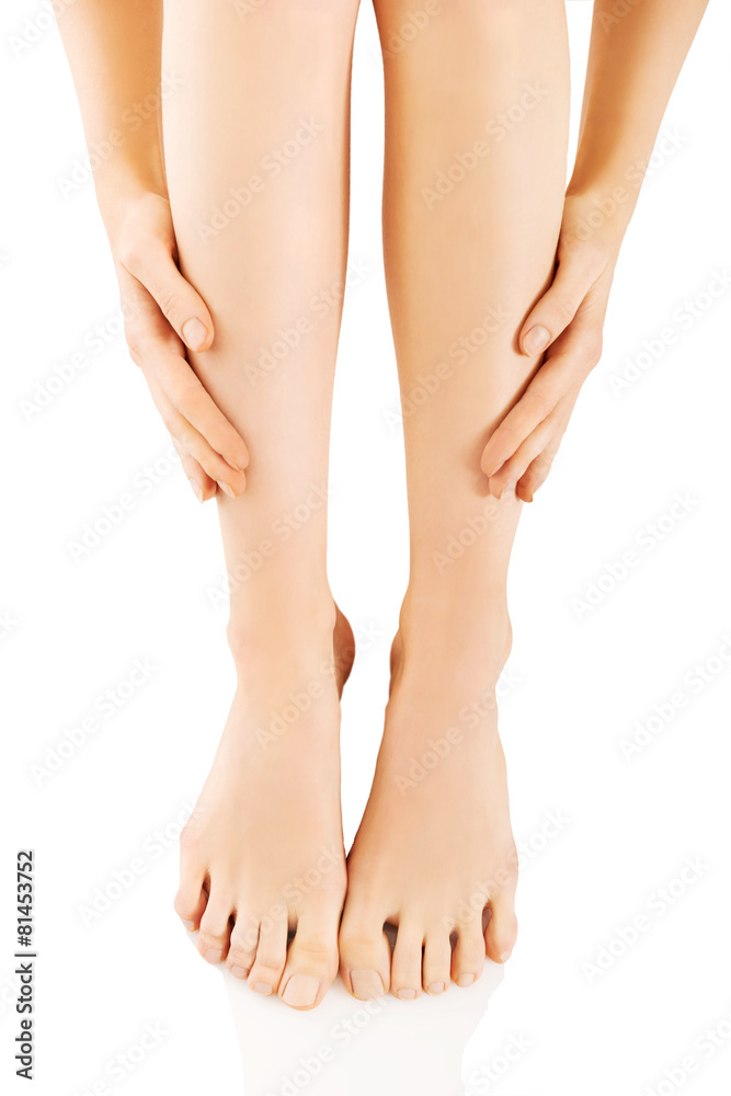 Woman massaging her legs after depilation Woman massaging her legs after depilation