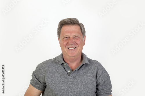 smiling mature man with grey polo shirt © travelview