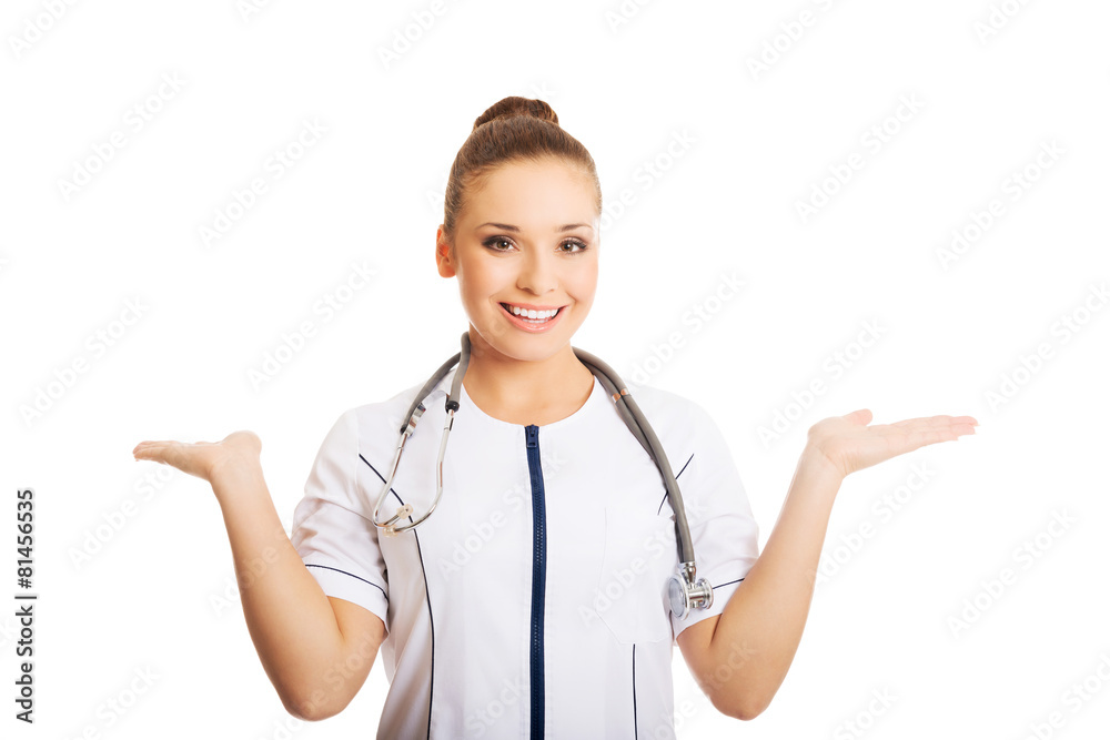 Female doctor presenting copyspace in both hands Female doctor presenting copyspace in both hands