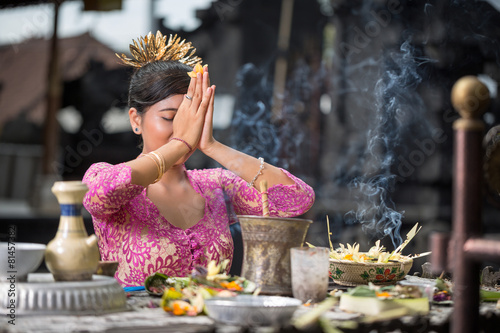 Beautiful Asian woman prays in the temple