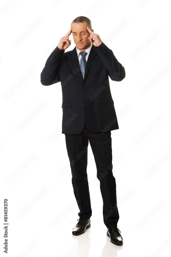 Full length pensive businessman touching head Full length pensive businessman touching head