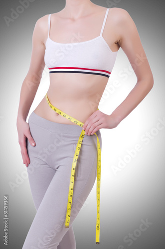 Young girl with centimeter in dieting concept