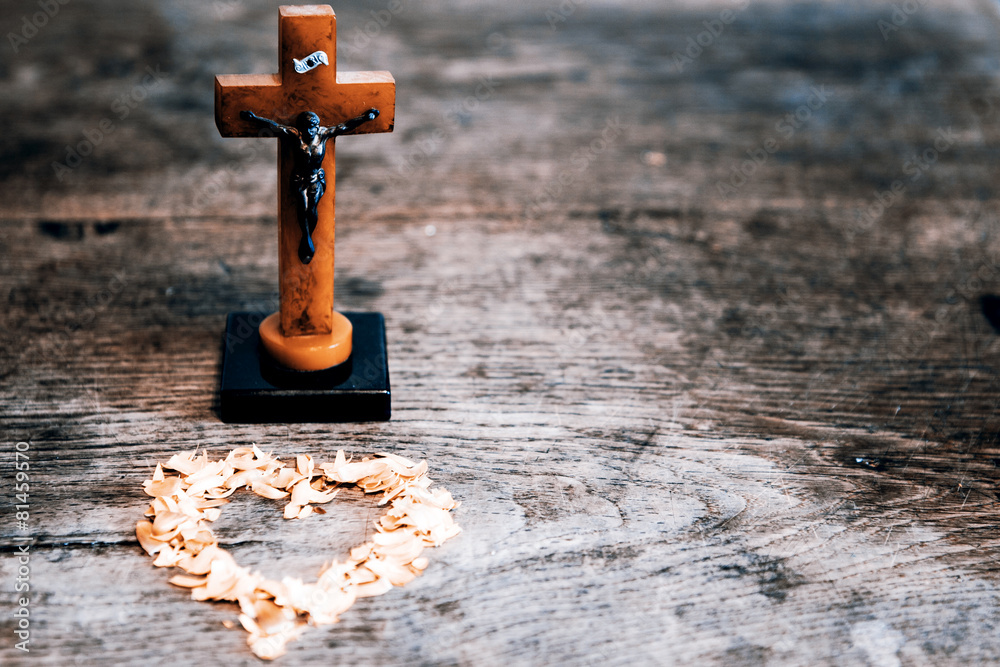 Beautiful old cross with jesus and heart from leafs on the old w Beautiful old cross with jesus and heart from leafs on the old w