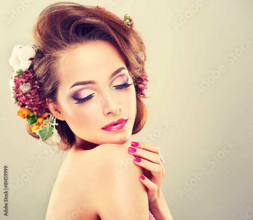 Fotografie Spring freshness. Girl with delicate pastel flowers in hair