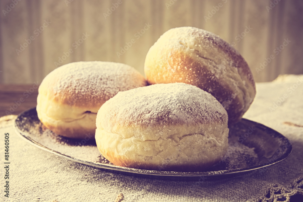Close-up image doughnuts on tray in old-style wallpaper Close-up image doughnuts on tray in old-style wallpaper