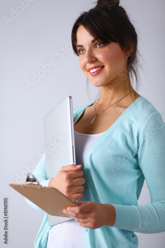 Woman with folder for documents on gray  background