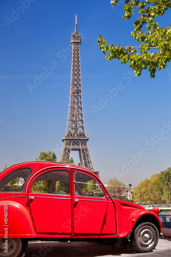 Eiffel Tower with old red car in Paris, France