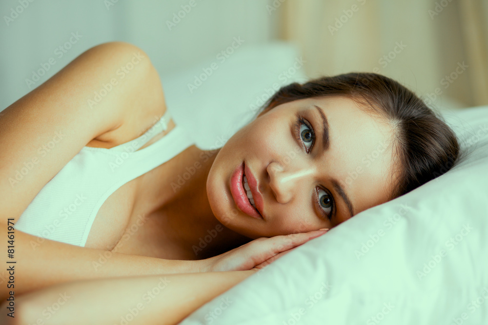 Fototapeta premium Pretty woman lying in bed