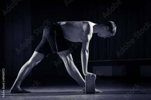 young man doing yoga in the gym, black and white 1