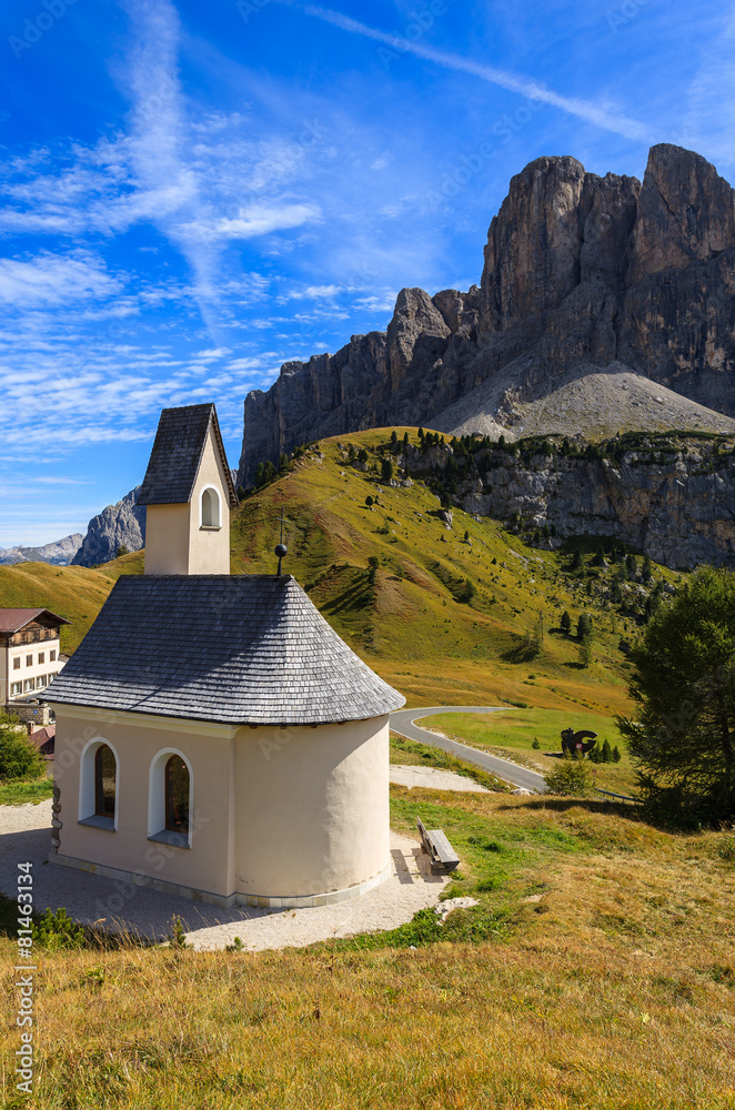 Church on Passo Gardena in Dolomites Mountains in autumn, Italy