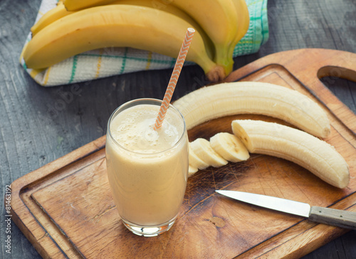 Fresh made Banana smoothie on wooden background