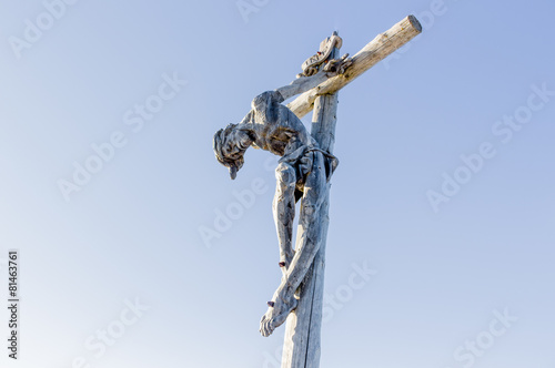 the crucifixion of Jesus Christ on top of the dolomites alps photo