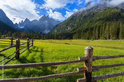 Fence on green pasture in Dolomites Mountains in summer, Italy © pkazmierczak