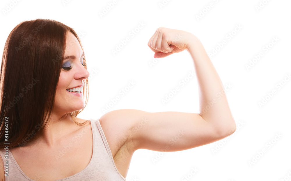 Austria, Teenage girl on track showing her muscles, smiling, portrait stock  photo