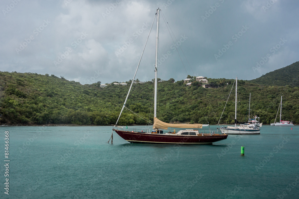 Obraz premium Sailboat Docked in Maho Bay