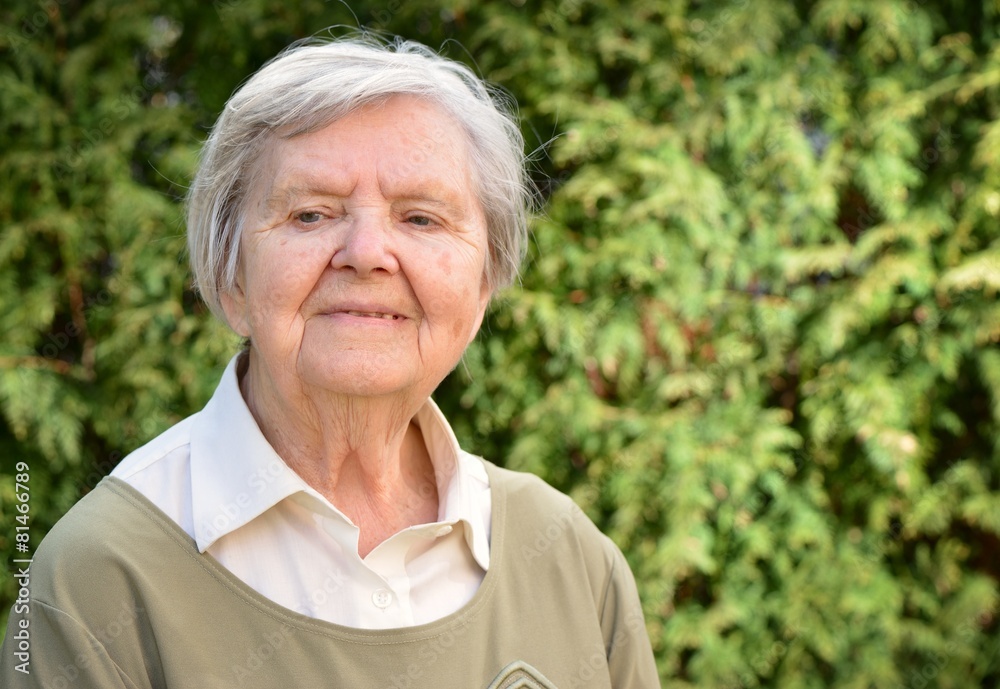 Senior woman smiling and dreaming in garden. Senior woman smiling and dreaming in garden.