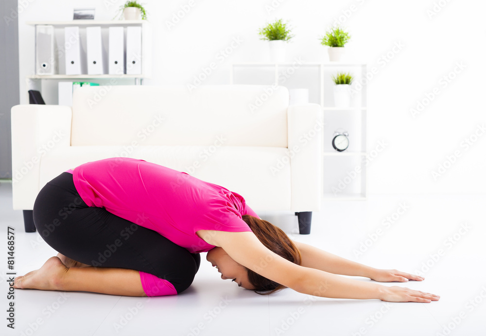 beautiful young woman stretching on the floor beautiful young woman stretching on the floor