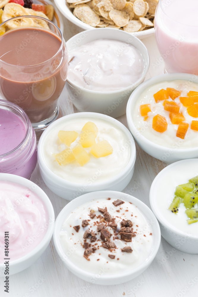 Assorted fruit yoghurts and breakfast ingredients, vertical Assorted fruit yoghurts and breakfast ingredients, vertical