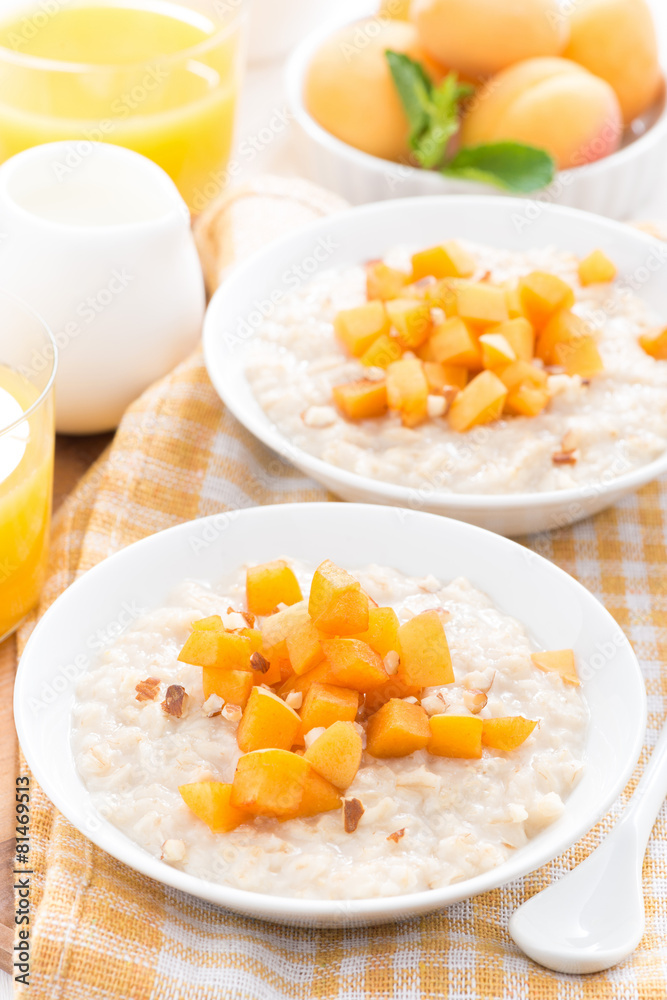plates of oatmeal with fresh apricots and nuts, orange juice plates of oatmeal with fresh apricots and nuts, orange juice