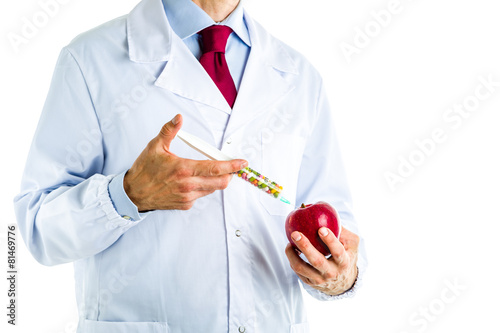 Doctor in white coat making an injection to a red apple