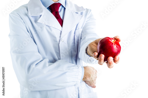 Doctor in white coat showing a red apple