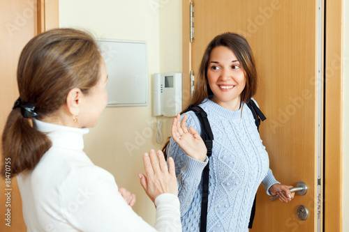 Mother sees off adult daughter at the door photo