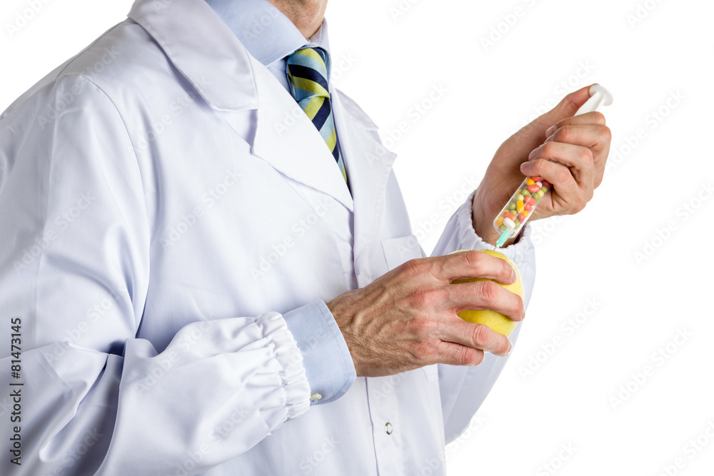 man in medical white coat makes an injection to yellow apple man in medical white coat makes an injection to yellow apple