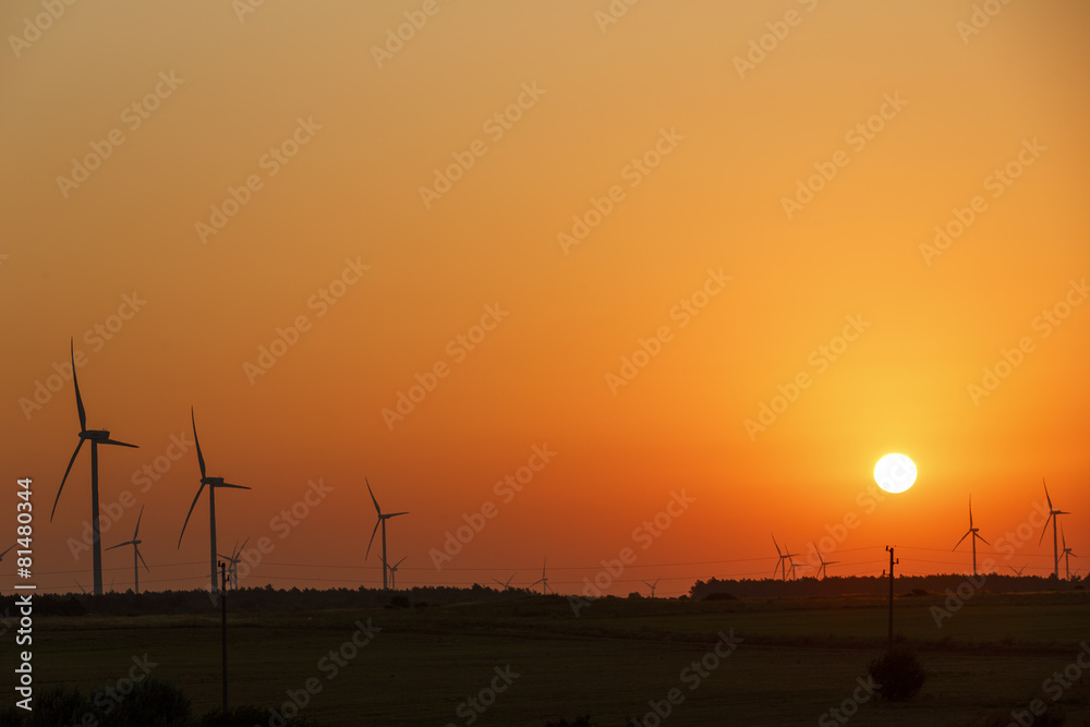 Fototapeta premium Windmills silhouettes at sunrise