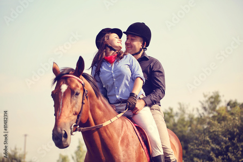 Couple riding a horse