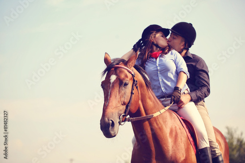 Couple riding a horse