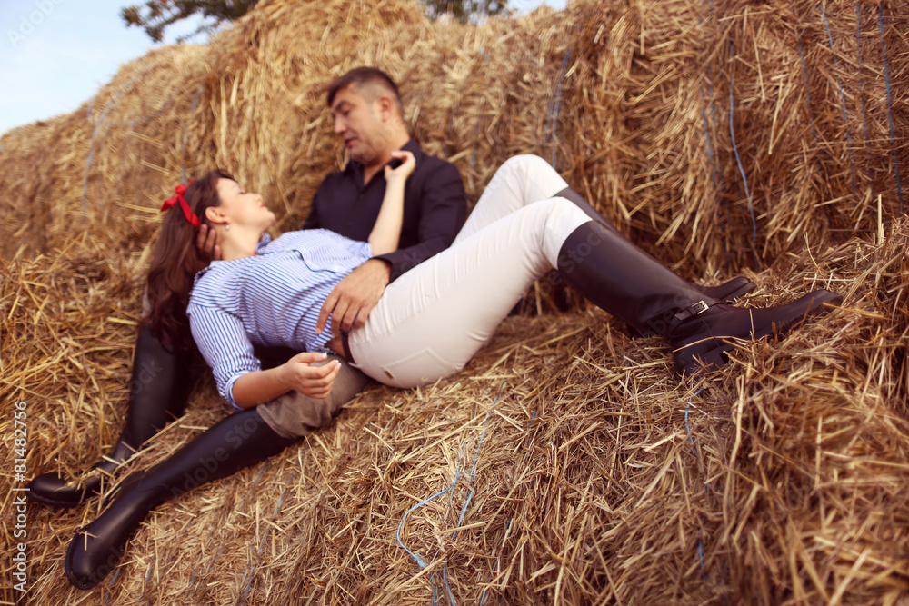 Couple near hay bale Couple near hay bale