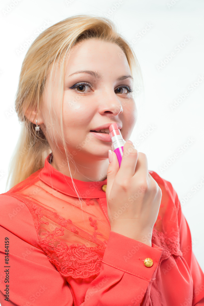 Business woman paints her lips Business woman paints her lips