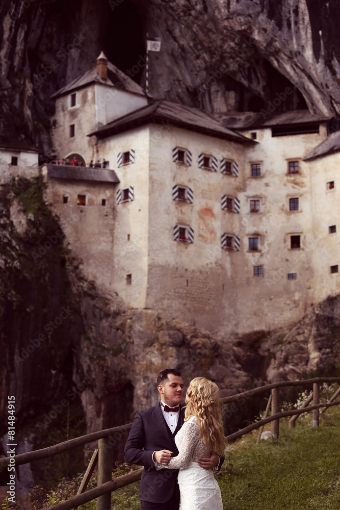 Bride and groom near castle