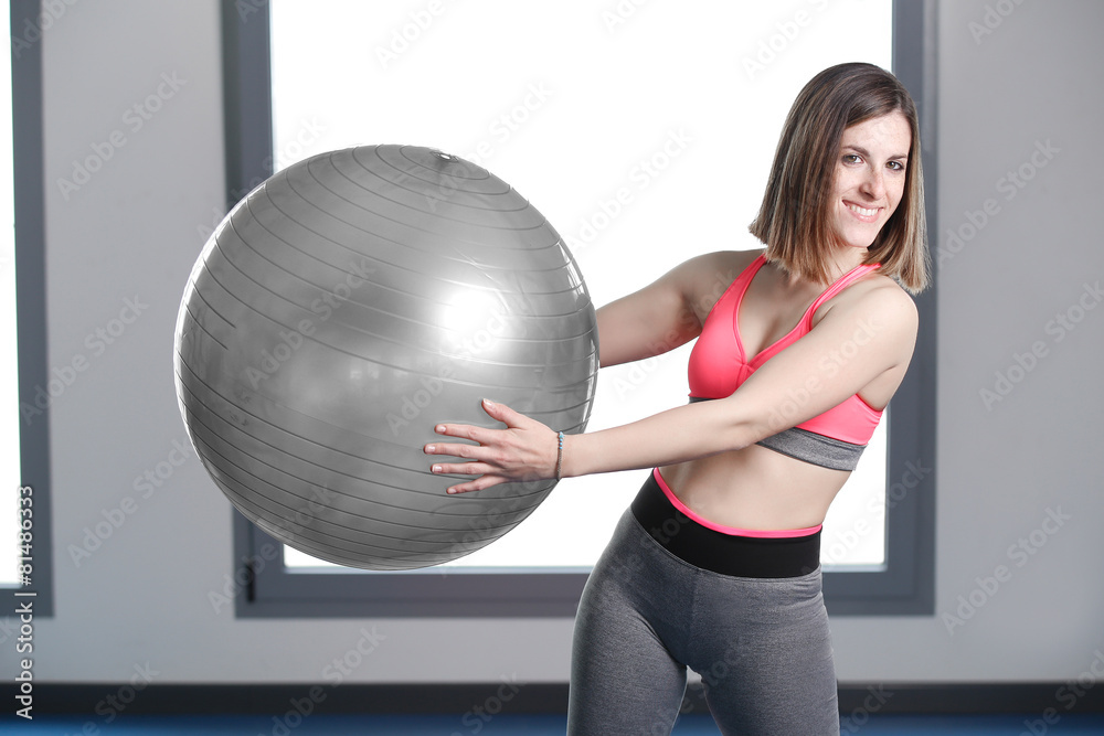 smiling woman with exercise ball in gym. smiling woman with exercise ball in gym.