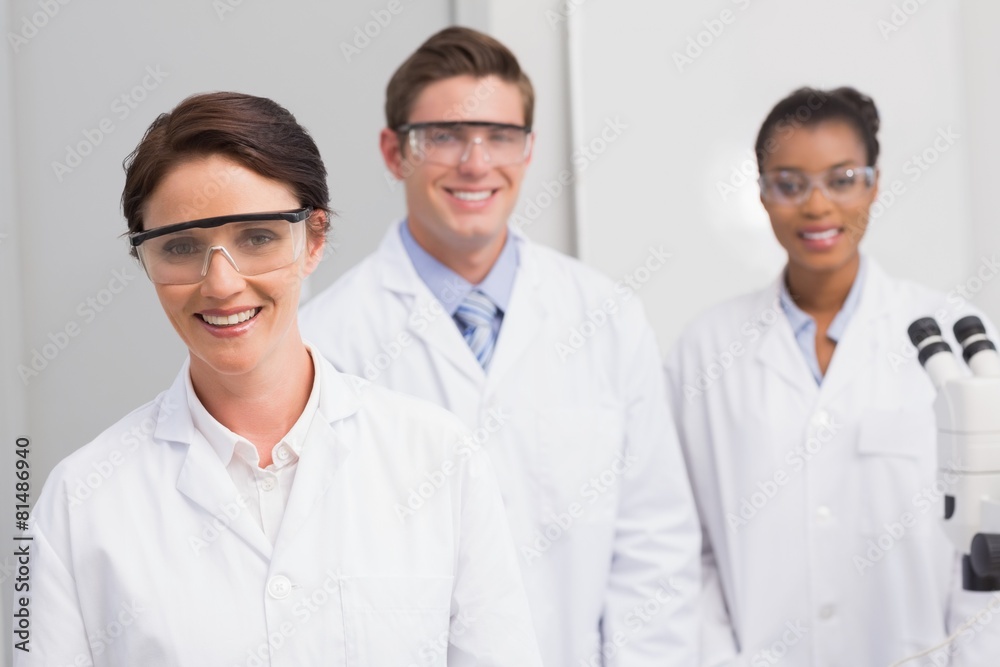 Scientists smiling and looking at camera Scientists smiling and looking at camera