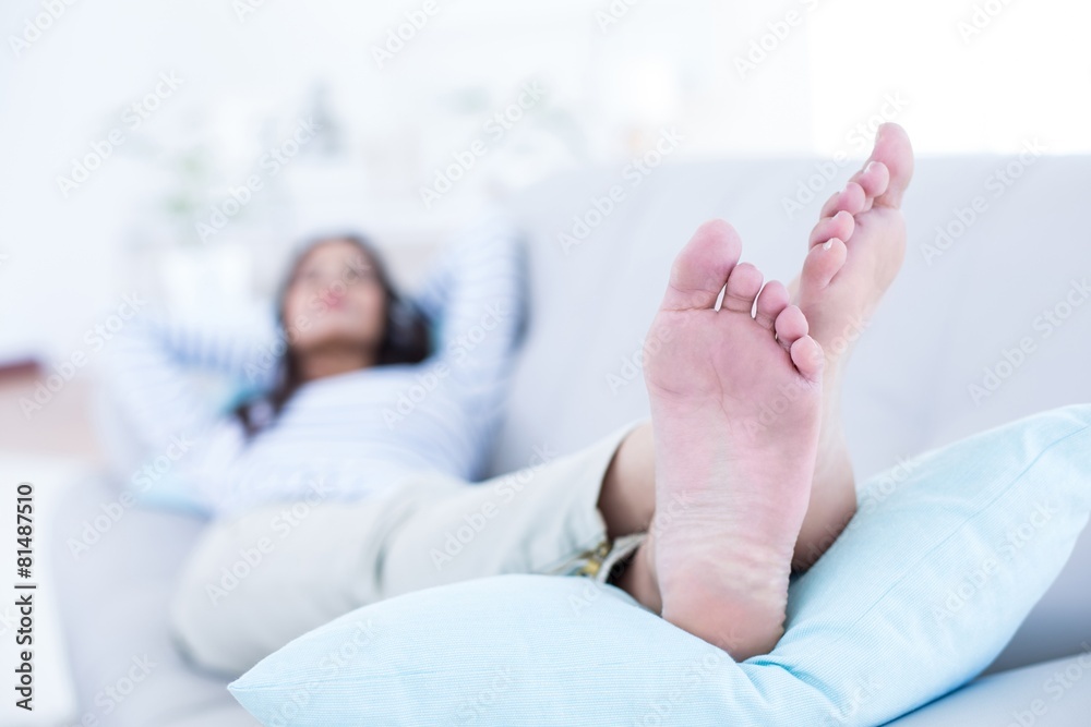 Smiling beautiful brunette relaxing on the couch Smiling beautiful brunette relaxing on the couch
