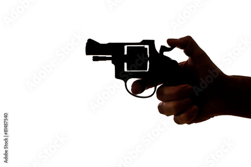 Silhouette of a mans hand with a handgun photo