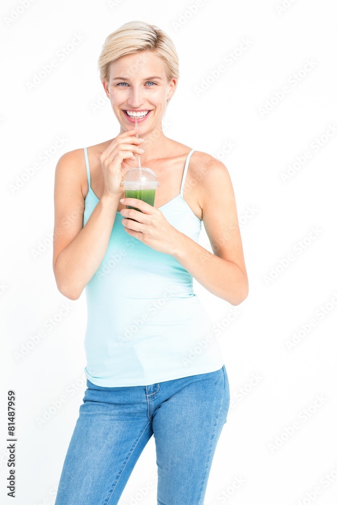 Beautiful woman drinking green juice Beautiful woman drinking green juice