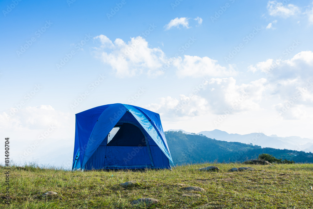 Tourists blue tent on mountain
