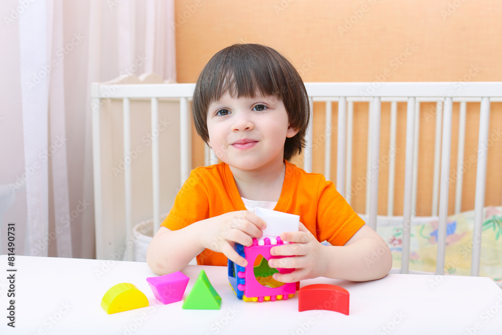 Happy little boy with educational toy