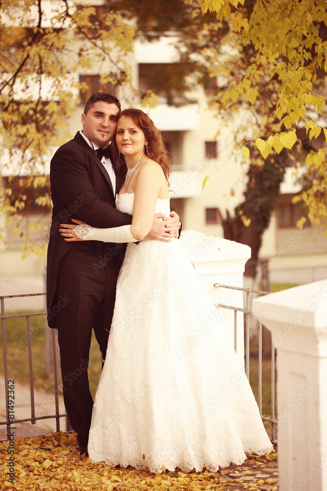 Bride and groom on autumn day