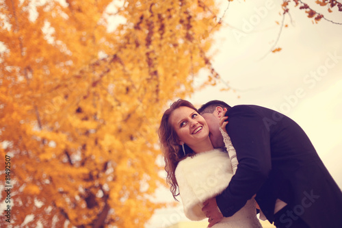 Bride and groom on autumn day 